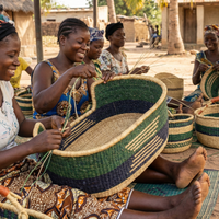 Women artisans weaving handmade pet baskets with natural elephant grass outdoors